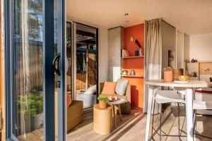 a small apartment with orange walls and a table at Key West in Harlingen