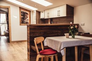 kuchnia ze stołem z wazonem kwiatów w obiekcie Appartement Pointschneiderhof w mieście Maishofen