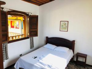 a bedroom with a bed and a window at Pousada Parque Imperial no centro de Paraty in Paraty