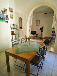 a dining room with a table with a vase of flowers on it at GITE AU COEUR DES GORGES DU VERDON in Quinson