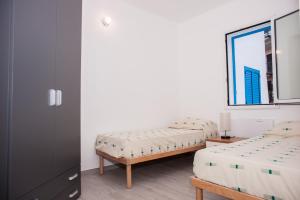 A bed or beds in a room at White & Blue