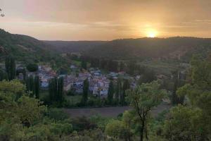 a view of a town with the sunset in the background at El Horno in Irueste