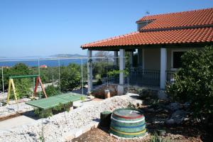 a house with a tennis court in the yard at Holiday Home Primosten (54) in Primošten