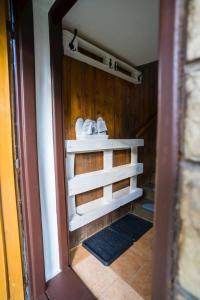 ein Badezimmer mit weißen Handtüchern an einer Holzwand in der Unterkunft Chalupa v Štefanovej in Žilina