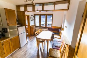 a kitchen and dining room with a table and chairs at Chalupa v Štefanovej in Žilina