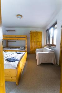 a bedroom with two bunk beds and a window at Chalupa v Štefanovej in Žilina