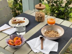 uma mesa com comida e uma taça de fruta e uma bebida em Le Village Sarzana em Sarzana