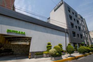 a building with a sign on the side of it at Hotel Catalina in Mexico City