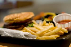 a plate of french fries and a sandwich and ketchup at Hotel Catalina in Mexico City