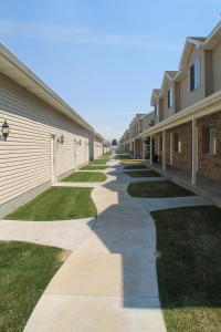 a walkway between two apartment buildings at 3 queen beds, 1 twin bed, 2 rooms, 1 and a half bath, self check-in, flexcation equipped in Idaho Falls