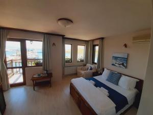 a bedroom with a bed and a view of the ocean at Guest House Fotini 2 in Sozopol
