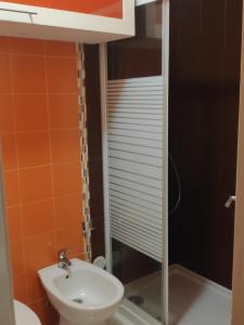 a small bathroom with a toilet and a sink at Casa do Mar in Figueira da Foz