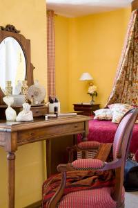 a room with a table and a bed and a chair at Hotel Le Viscos - Teritoria in Saint-Savin