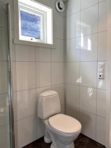 a bathroom with a white toilet and a window at Aurland Feriehus in Aurland