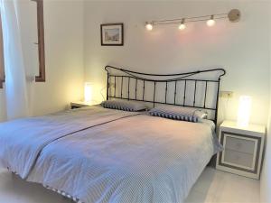 a bedroom with a large bed with two night stands at Villa Sina in Monte Pego