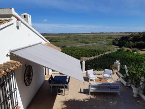 a patio with chairs and a white roof with a view at Villa Sina in Monte Pego