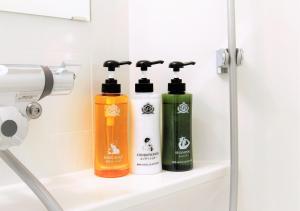 two bottles of soap on a shelf in a bathroom at APA Hotel Namba Shinsaibashi Nishi in Osaka