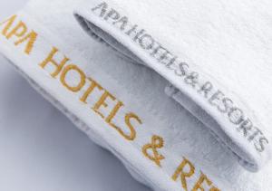 three white towels with the words new research written on them at APA Hotel Namba Shinsaibashi Nishi in Osaka