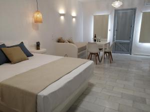 a bedroom with a bed and a living room at Plaka's house seaside view in Plaka