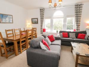 a living room with a couch and a table at Station Flat in Betws-y-coed