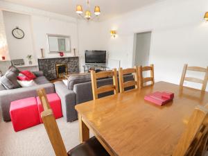 a living room with a couch and a table at Station Flat in Betws-y-coed