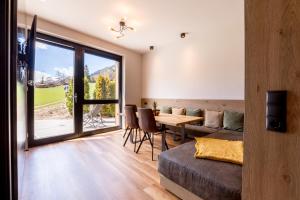 salon ze stołem i kanapą w obiekcie DER WOLF -Suiten w mieście Sankt Anton am Arlberg