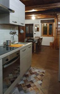 a kitchen with a sink and a counter top at ViviMontagna Mathilda in Perosa Argentina