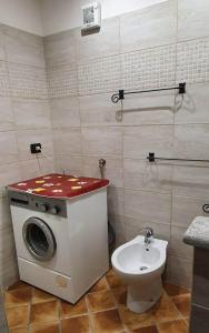 a bathroom with a washing machine and a toilet at ViviMontagna Mathilda in Perosa Argentina +19 photos