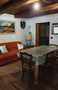 a living room with a table and a couch at ViviMontagna Mathilda in Perosa Argentina +19 photos