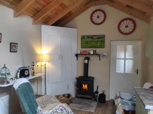 a living room with a fireplace and a stove at Pat Tadys in Manorhamilton