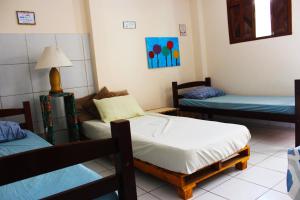 a room with two beds and a couch at Hostel das Canárias in Natal +173 photos