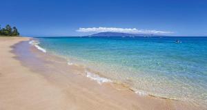 a beach with the ocean and the shoreline at Wonderful Maui Vista-Kihei Kai Nani Beach Condos in Kihei