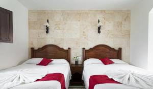 Postel nebo postele na pokoji v ubytování La Aurora Hotel Colonial