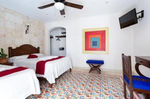 Postel nebo postele na pokoji v ubytování La Aurora Hotel Colonial