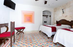 Postel nebo postele na pokoji v ubytování La Aurora Hotel Colonial
