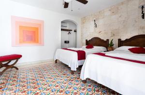 Postel nebo postele na pokoji v ubytování La Aurora Hotel Colonial
