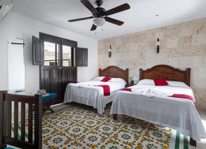 Postel nebo postele na pokoji v ubytování La Aurora Hotel Colonial