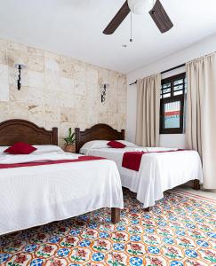Postel nebo postele na pokoji v ubytování La Aurora Hotel Colonial