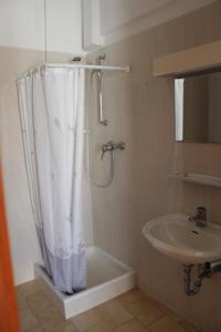 a bathroom with a shower curtain and a sink at Michael Apartments in Rethymno +26 photos