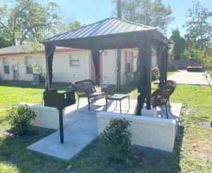 a gazebo with two benches and a grill at Villas at Valencia Bay in Gulfport