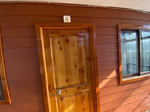a wooden room with a door and a window at Depto N°4 Temuco Centro in Temuco