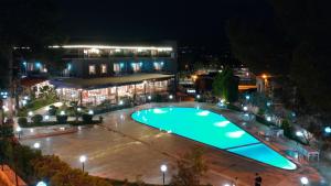 a large pool in front of a building at night at Pamukkale Whiteheaven Suite Hotel in Pamukkale