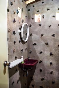 a bathroom with a rock climbing wall with a sink at BB Dorm Koh Kood in Ko Kood +37 photos