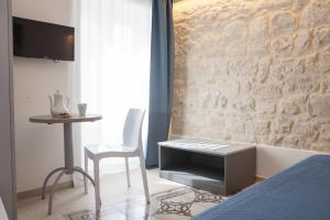 a bedroom with a bed and a table and a chair at Candelieri19 in Modica