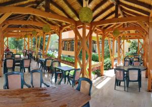 a wooden pavilion with tables and chairs in a restaurant at Family Hotel Iv in Velingrad