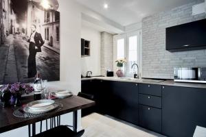 a kitchen with a black and white photo on the wall at S H E N K I N ChicLife Design Apt next to the Museum in Bergamo