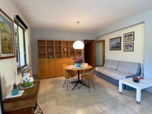 een woonkamer met een tafel en een bank bij La casa nel bosco in Trecastagni