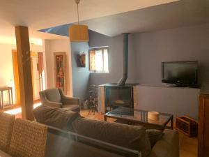 a living room with a couch and a fireplace at Casa Clemente II in La Hiruela