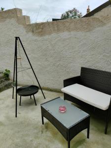 a patio with a couch and a table and a swing at Au cœur de la Sologne in Romorantin +4 photos