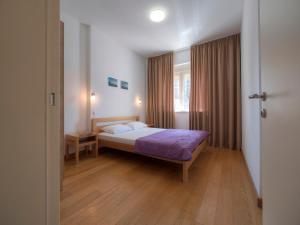 a bedroom with a bed in a room with a window at Seaside Rest Apartments in Budva